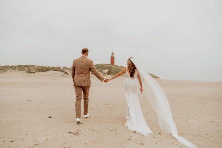 Een intieme trouwreportage op het strand van Texel met de vuurtoren. foto: Wilco de Haan Fotografie, trouwfotograaf Winschoten, Groningen